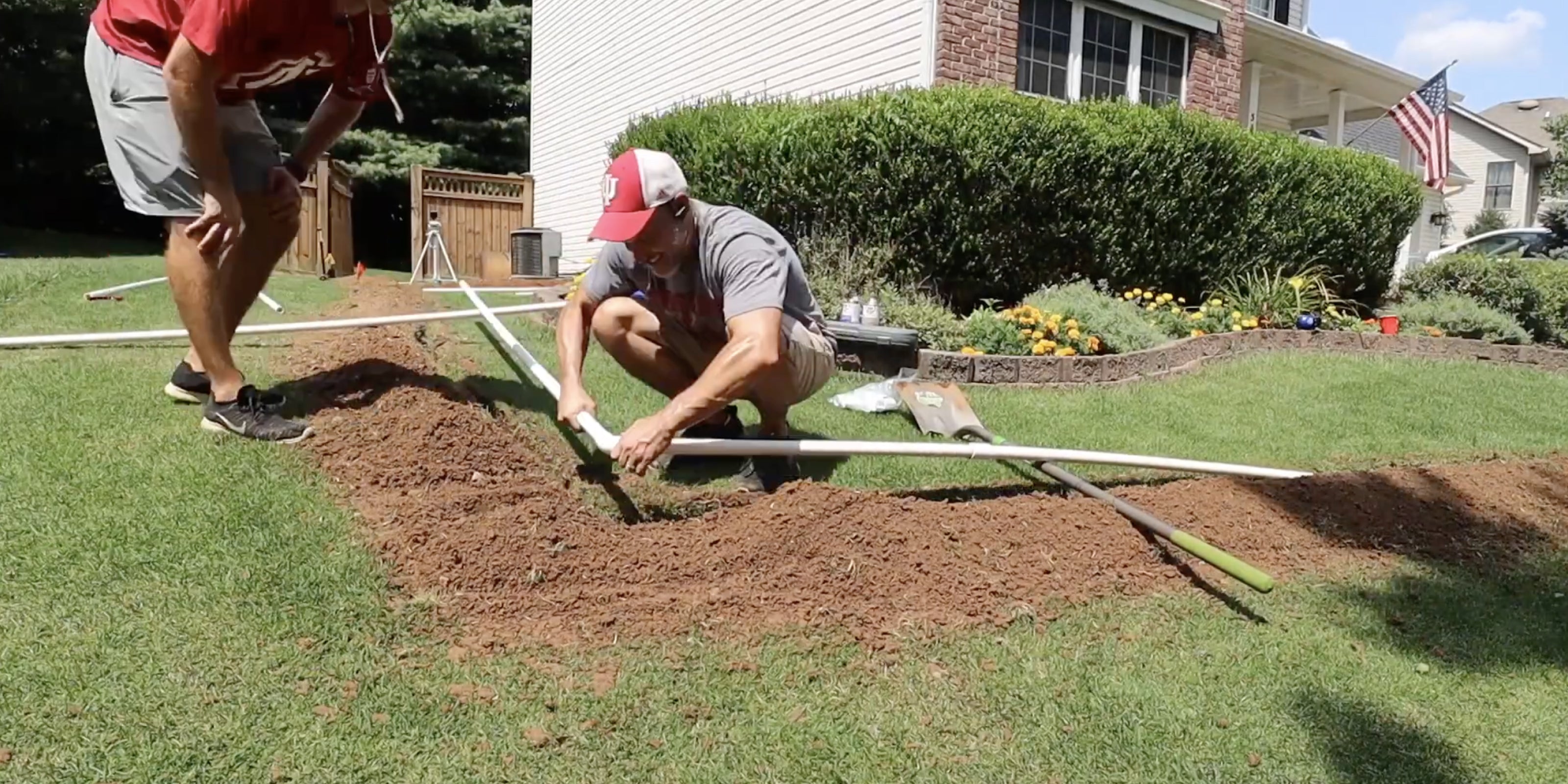 DIY installer assembling PVC piping in narrow trench for Irrigreen smart in-ground sprinkler system